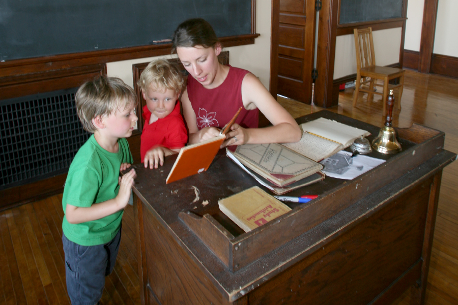 Guest reads a Reed Schoolbook to her children